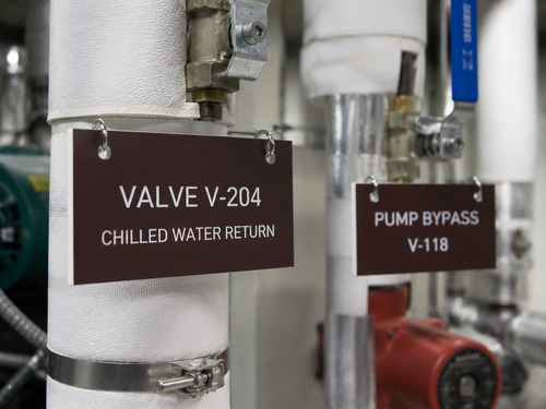 LYS-7013 engraved valve and pump identification laminate tags installed in a mechanical room application