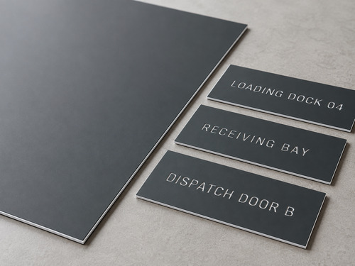 LYS-7020 loading dock identification engraving laminate with thin matte charcoal face continuous white core and slightly recessed white wording