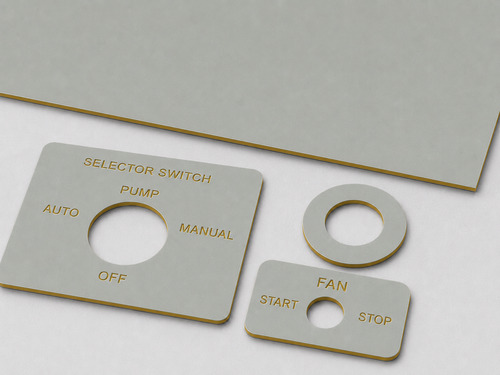 LYS-7022 selector switch legend plate material with thin matte sage-gray face continuous mustard-gold core and slightly recessed gold legends