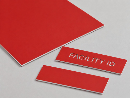 LYS-7023 matte red white two-ply sign plastic with thin red cap continuous white core and slightly recessed facility ID engraving