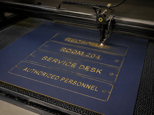 LYS-7038 full navy gold engraving sheet being processed on a realistic large CO2 laser honeycomb table