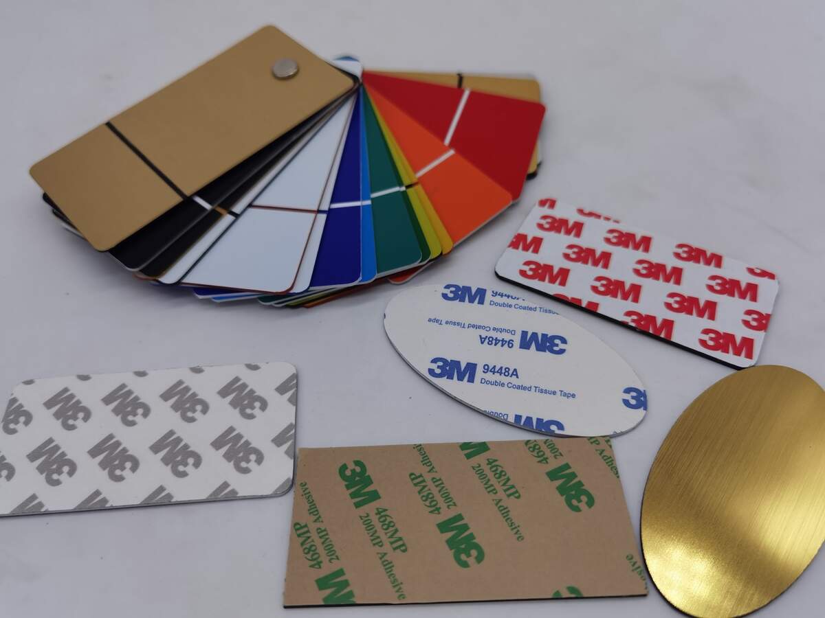 Real LYSHIRE engraving plastic samples showing 3M 468MP and other adhesive backing options