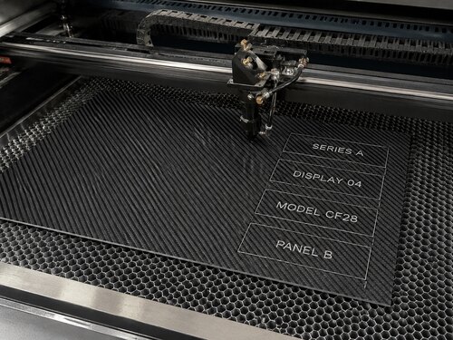 LYS-8281 carbon fiber effect black white engraving plastic processed into display inserts on a large CO2 laser honeycomb table