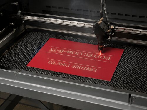 Large CO2 laser mirror engraving the red rear coating of clear acrylic reverse engraving material