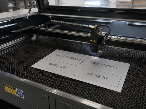 Large CO2 laser mirror engraving the satin-silver rear coating of reverse-engravable acrylic