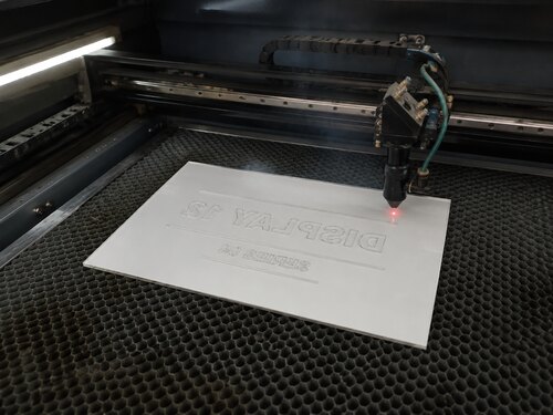 Large CO2 laser mirror engraving the white rear coating of clear acrylic reverse engraving material