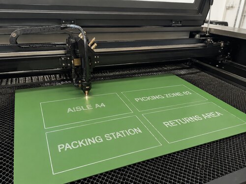 Large CO2 laser processing a green white laser engraving plastic sheet for internal logistics identification
