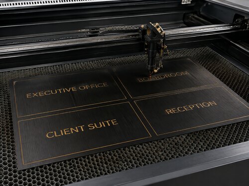 LYS-8273 brushed black gold engraving plastic processed into corporate interior signs on a large CO2 laser honeycomb table